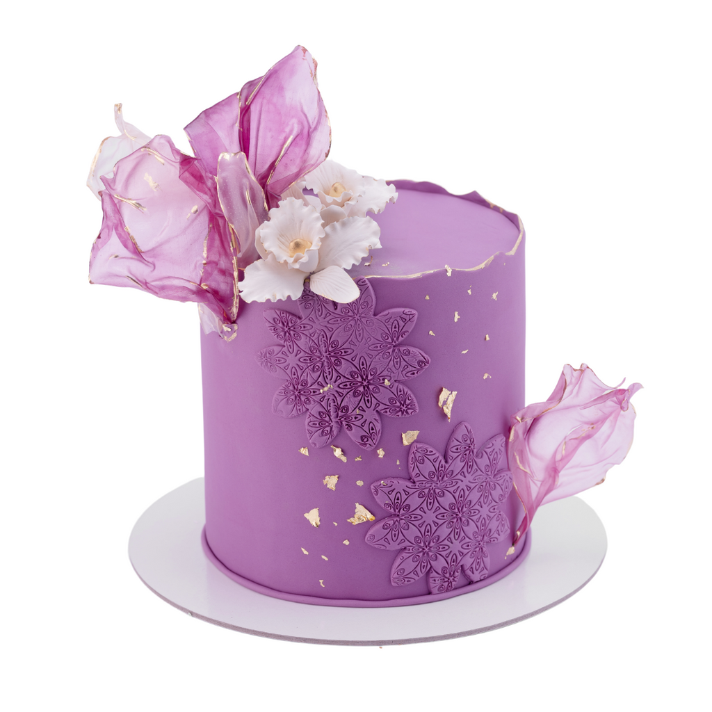 Purple drip cake with sprinkles and mini choco bars - FunCakes